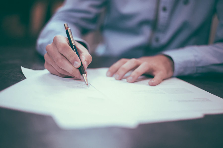Homeowner reviewing insurance claim documentation for water heater damage in Phoenix
